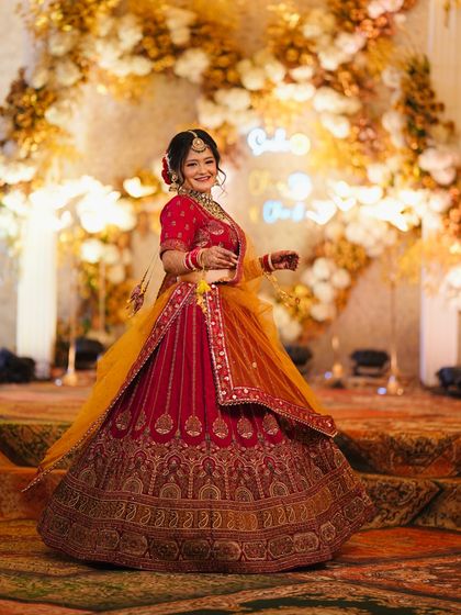 Another beautiful shot of bride Proneeta. Her happy smile and the stunning floral backdrop create a perfect wedding day portrait.