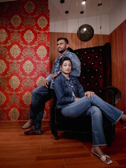 A stylish shot in our royal room, with the couple posing on a throne-like chair surrounded by unique lamps.