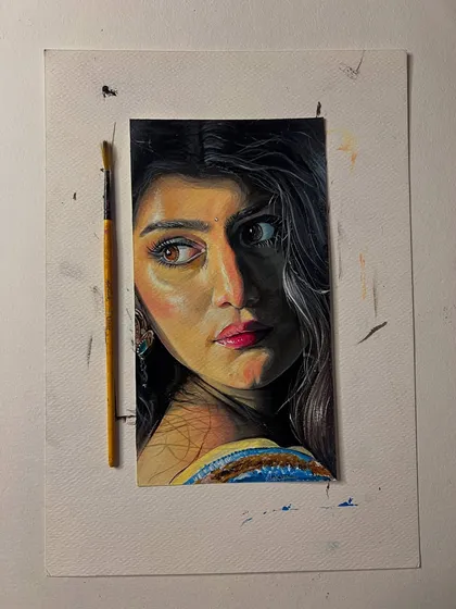 The portrait on my workspace, with a brush for scale. I take great care to make each custom portrait a special piece of art.
