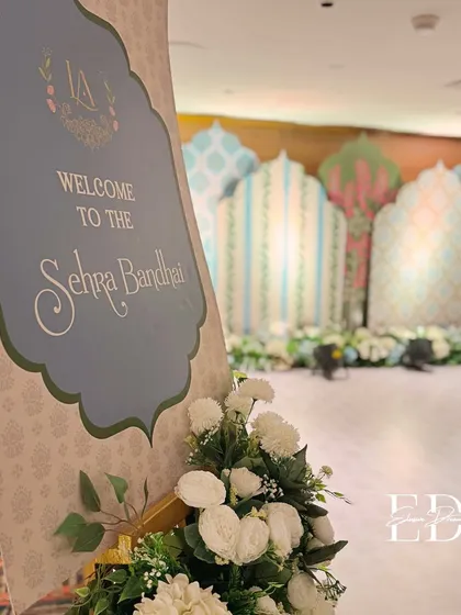 The entrance to the 'Sehrabandi' ceremony, with the welcome sign offering a glimpse of the elegant, patterned backdrop in the distance. The design is cohesive and sophisticated.