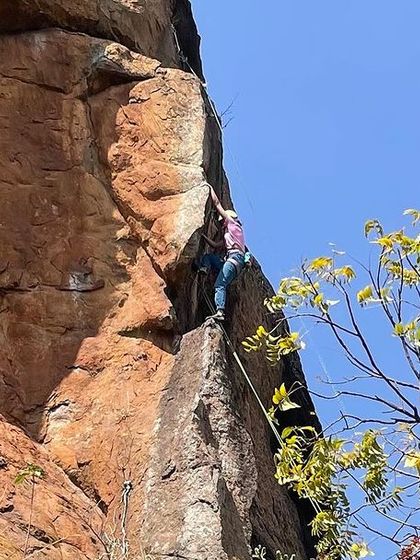 A climber on a steep, featured section of a route at Talai Betta. This crag offers excellent quality rock and challenging climbing.