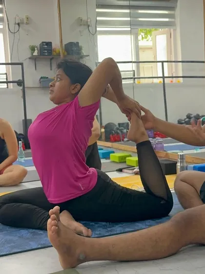 Giving a gentle adjustment in Eka Pada Rajakapotasana (One-Legged King Pigeon Pose). Teaching is an art connected to the heart, and it's about guiding students to find growth in their practice.