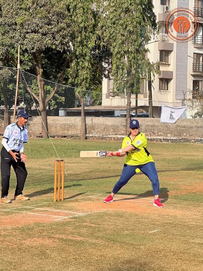 A female batter connects with the ball during a PPL match, showcasing the power and confidence of our participants in the women's league.