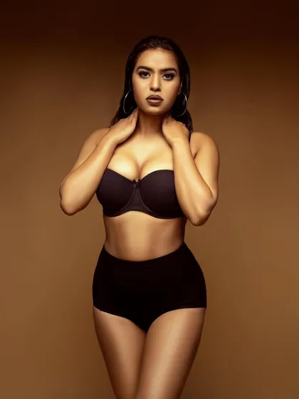 A simple and elegant lingerie portrait. Using a soft, warm light against a neutral background, I aimed to create a timeless and tasteful shot that focuses on form and mood.