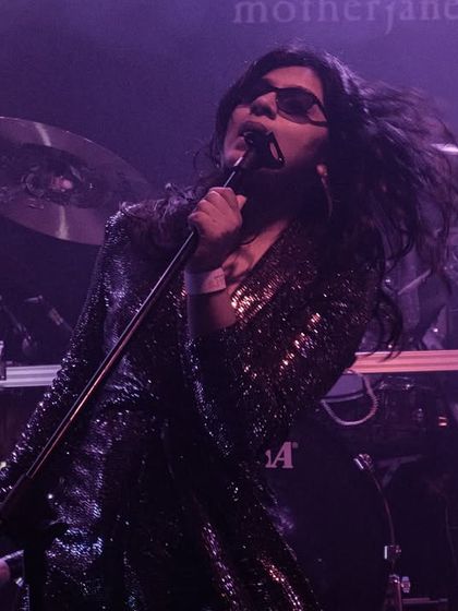 A dramatic shot from our opening act for the legendary band Motherjane. The stage lights and smoke create a powerful atmosphere, highlighting the intensity of our performance.