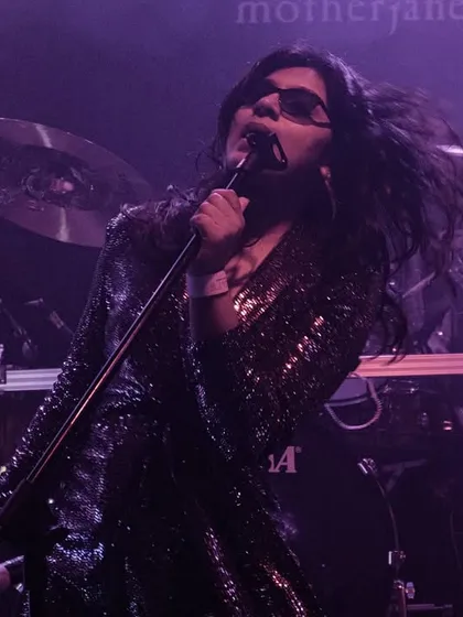 A dramatic shot from our opening act for the legendary band Motherjane. The stage lights and smoke create a powerful atmosphere, highlighting the intensity of our performance.