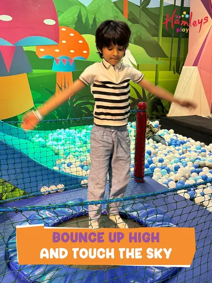 Bounce up high and touch the sky! A young boy enjoys our trampoline zone, a favorite spot for kids to burn off energy and experience the simple joy of jumping.