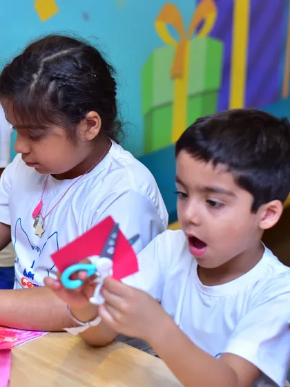 This is the moment of discovery I love to see. In my creative workshops, kids get to explore their curiosity and learn by doing, like this young camper completely absorbed in an arts and crafts project.