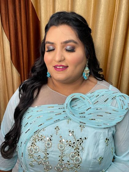 Full glam for this Sangeet bride. The look features dramatic glittery eyes and a bold lip, perfect for a night of celebration.