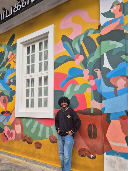 Posing against a vibrant mural in the streets of Pondicherry. Our city getaways are full of these colorful discoveries.