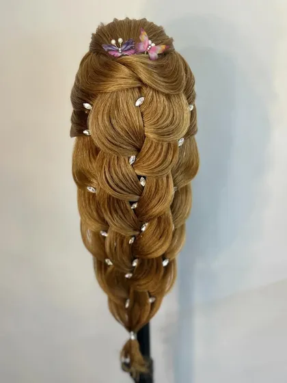 This version of the braid uses delicate butterfly accessories, showing students how to customize a style based on the client's theme.