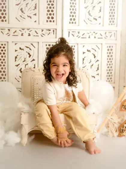 A burst of pure joy from this two-year-old boy, laughing heartily during his birthday milestone session.