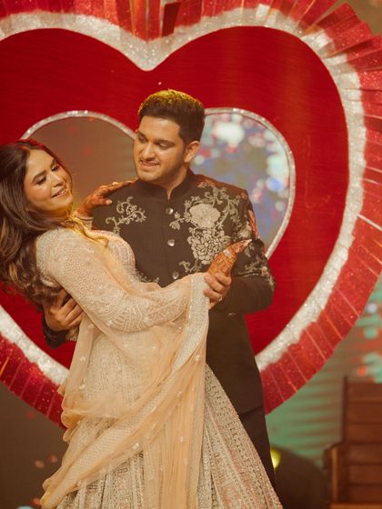 We often use props to add a thematic touch. The giant heart prop for Saaransh and Yashi's performance created a perfect Bollywood-style backdrop for their romantic duet.