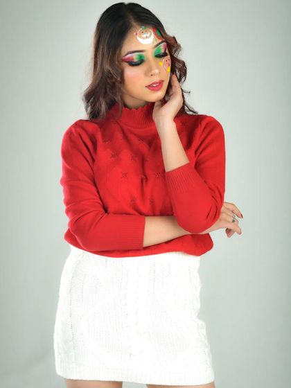 A wider shot of the Christmas makeup, pairing the detailed face art with a cozy red sweater and white skirt. This shows how the makeup can be part of a full festive outfit.