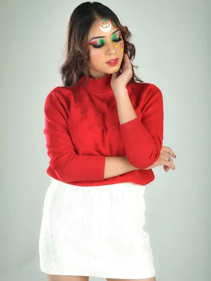 A wider shot of the Christmas makeup, pairing the detailed face art with a cozy red sweater and white skirt. This shows how the makeup can be part of a full festive outfit.