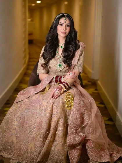 A full portrait of our relaxed and happy bride. Her makeup is glamorous yet soft, with a focus on her eyes and a beautiful nude lip.