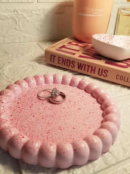 Our bubble round trinket tray in pink with red speckles, made from concrete. It's a sturdy and stylish spot for your everyday rings and jewelry.