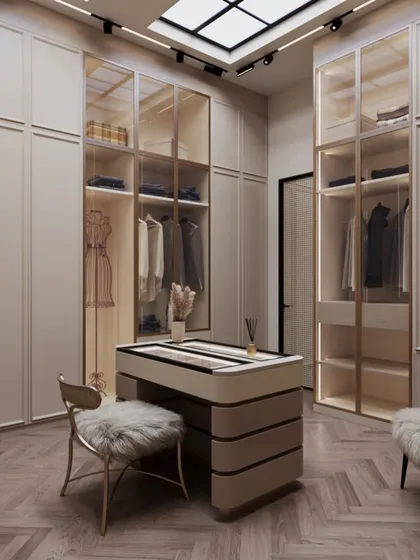A walk-in wardrobe should feel like a personal boutique. I designed this space with soft beige tones and a central accessory island to feel warm and expansive. A faux skylight overhead floods the room with a natural, diffused glow, making the daily ritual of getting dressed feel like an airy and inviting indulgence.