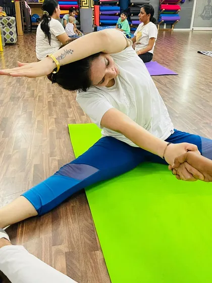 A close-up of an assisted side stretch. With my help, this student can safely extend further, opening up her side body and shoulders.