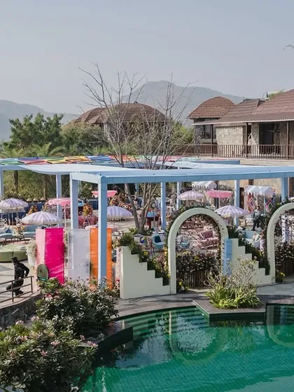 A dreamy pastel setup by the poolside for a Haldi ceremony. The soft hues of the decor, combined with the tranquil water and mountain view, created a serene and aesthetically pleasing haven.