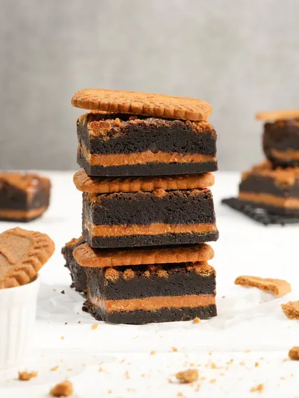 A clean, crisp shot of stacked Biscoff brownies before the caramel pour. This image focuses on the texture and layers, perfect for catalogue or website use.