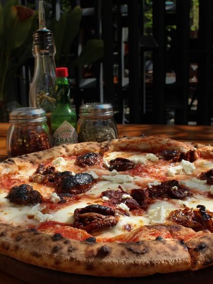 Another angle of the Smokey Marzano, showing the texture of the sourdough crust and the generous toppings. It's a perfect pizza for a weekend treat.