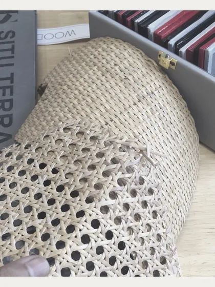 Weaving together different materials. Here, we are exploring how natural cane webbing pairs with terrazzo and other finishes. This process of discovery is key to our innovative designs.