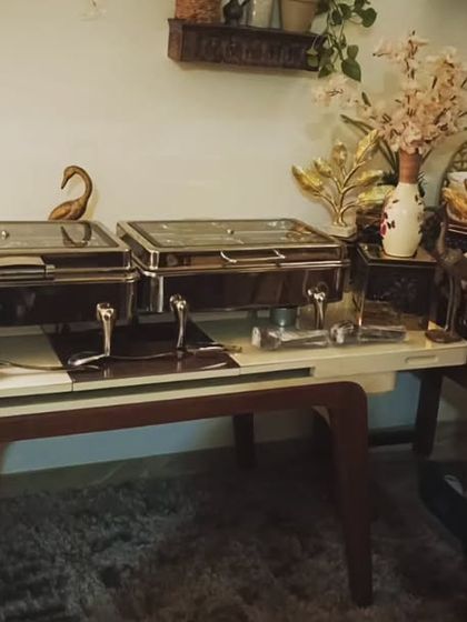 A cozy and intimate setup for a gathering of 20 guests in South City 2, Gurugram. The arrangement includes a main buffet and a separate beverage station for convenience.