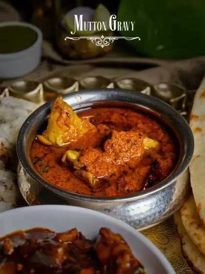 A close-up of the hearty Mutton Gravy from the Dostana Thaal, perfect for dipping a piece of fresh naan into.
