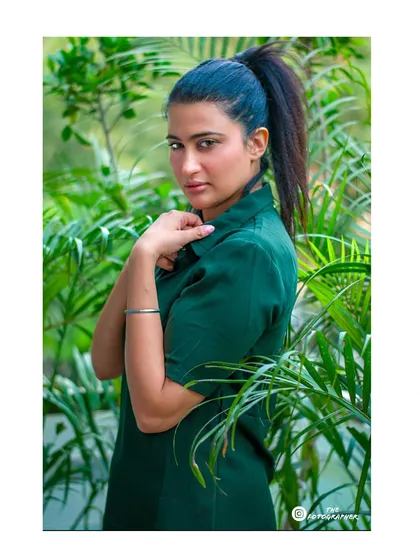Another shot from the same location, with the model framed by plants. This composition creates a beautiful connection with nature.