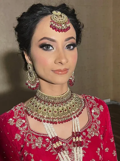 A stunning portrait of the bride looking directly at the camera. Her eyes are the star of the show, enhanced with soft glam makeup and beautiful lenses.