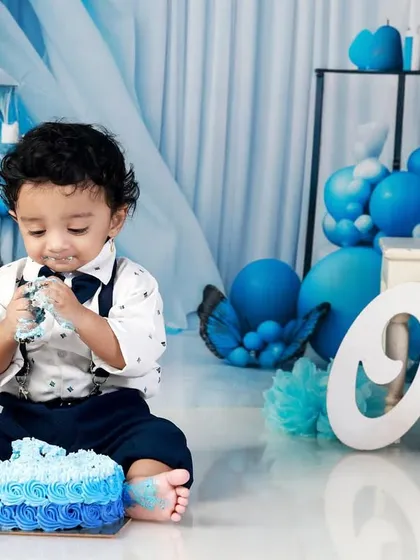 Nothing says "Happy First Birthday" like a cake smash! This little one is having the time of his life with his own cake against our custom blue balloon backdrop. I focus on capturing the messy, candid, and joyful moments of this big milestone.