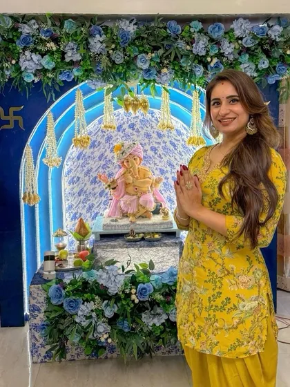 Presenting our colour of the season, 'Aqua Blue'. This Ganpati mandap features a stunning floral arch in shades of blue and white, with delicate hanging mogra strings. It's an elegant and fresh take on festive home decor.