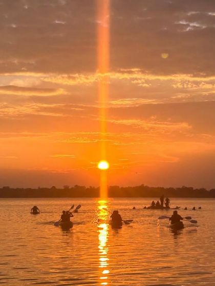 A magical sunset at Vani Vilas Sagar, with kayakers enjoying the last light of the day on the water.
