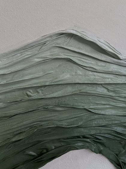 A macro detail shot of the gradient in the green fabric texture. You can see the subtle shifts in color from light to dark green, adding another layer of visual interest.