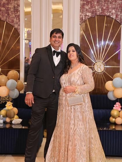 The same golden gown, looking absolutely radiant at a party. It’s a full-length, long-sleeved piece that exudes elegance and glamour.