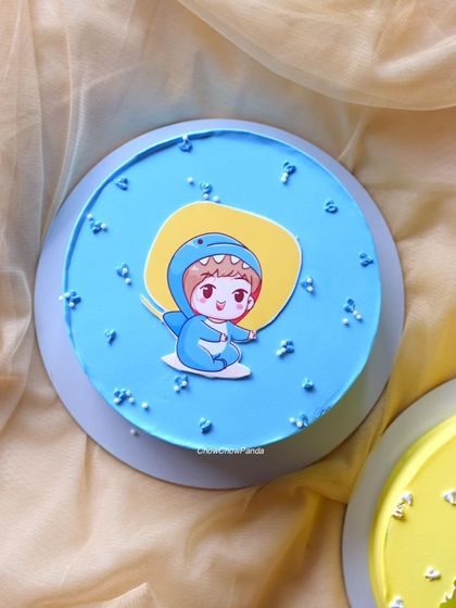 Another cute character cake, this one with a blue theme and a cartoon topper.