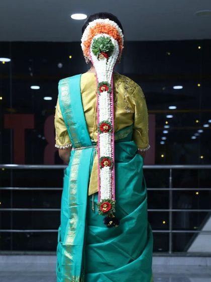 The back view of a traditional half-saree look, showcasing the intricate floral hairstyle that I created to match the outfit.