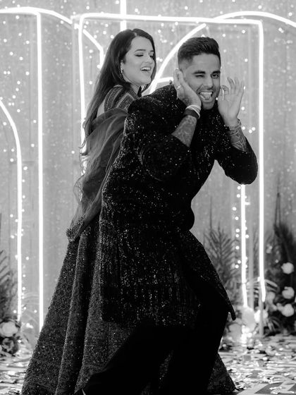 A playful black and white shot of cricketer Surya Kumar Yadav and his wife sharing a fun moment on the dance floor.