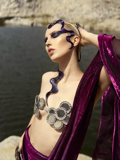 A wider shot of the 'Siren of the Sea' look, showing the interplay between the sculpted purple hair, the dark eye makeup, and the custom mirror bralette.