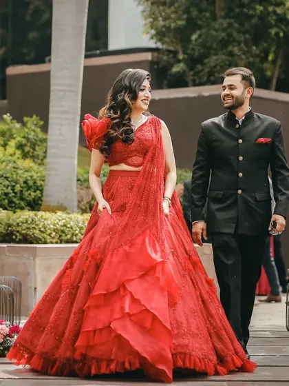 A walking shot of the couple. The bride's makeup is designed to look perfect in both posed and candid photos.