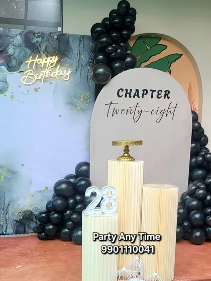 A full view of the sophisticated 'Chapter Twenty-eight' birthday decoration.