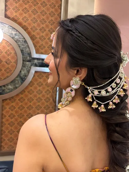 A side view of the floral fishtail braid, showing how the accessory is placed at the crown and the flowers are scattered throughout the length of the braid.