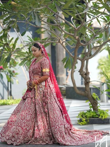 A full-length shot showing the grandeur of the bridal lehenga. The makeup is balanced to complement the magnificent outfit.