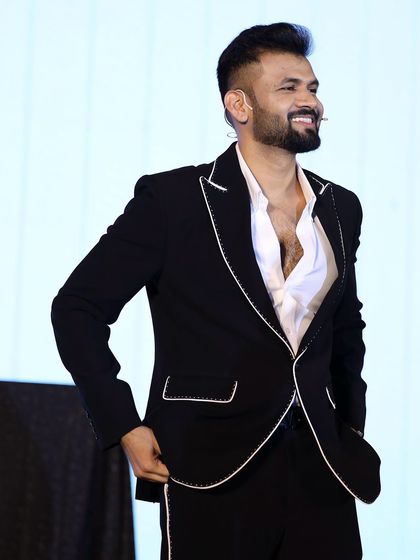 Our client looking sharp and confident in his bespoke black suit. The tailored fit ensures a sleek profile, perfect for any formal event.