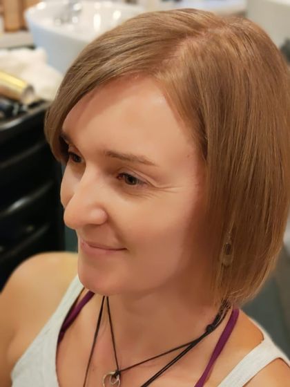 A happy client after her chic bob haircut. This precision cut is modern, stylish, and easy to maintain.