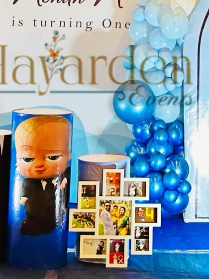 A personalized Boss Baby setup, featuring a custom photo collage frame. This is a wonderful way to include personal memories in the party decor.