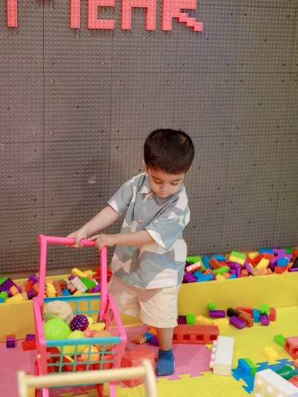 This little shopper is gathering blocks in our construction zone during a unicorn-themed party. Imagination knows no bounds here.
