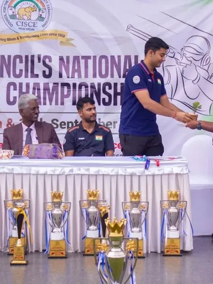 A young winner receiving his award on stage during the CISCE Council's National Shooting Championship in 2023.