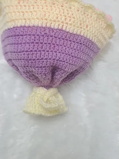 A view of the bottom of the bouquet, showing the tie that holds it together. This small detail completes the look of a classic, hand-tied flower arrangement.